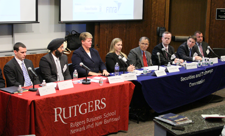 Two tables of panelists speaking at the event