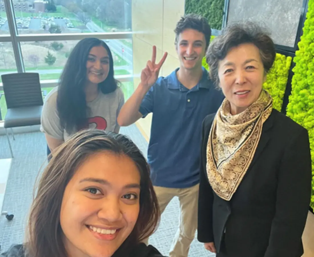 students posing with dean lei