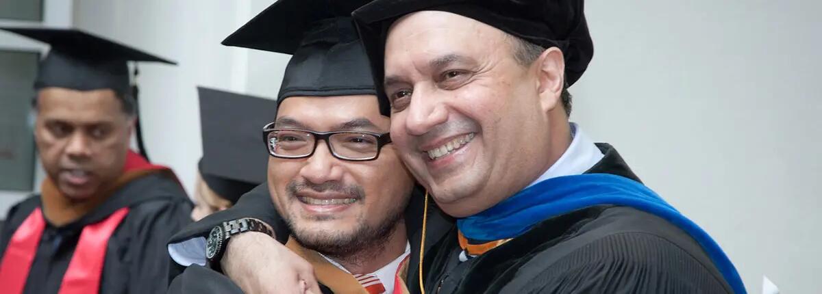 Rutgers EMBA graduate with program director, Farrokh Langdana.