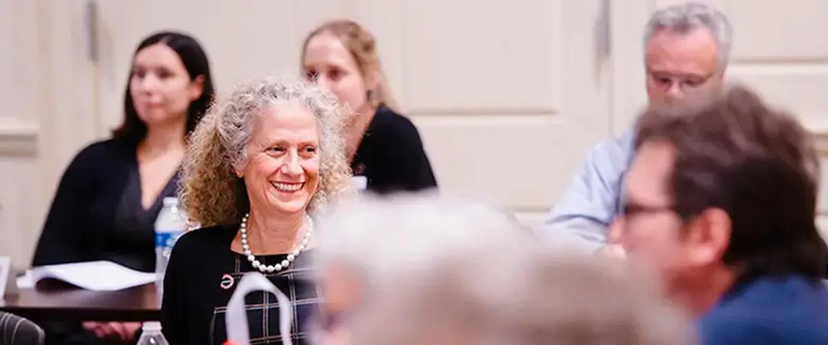 Photo of Joanne B. Ciulla and others sitting and paying attention at an event