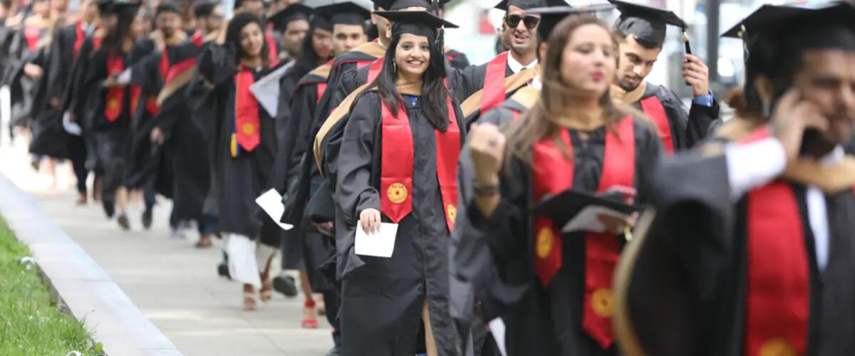 students walking to graduation ceremony